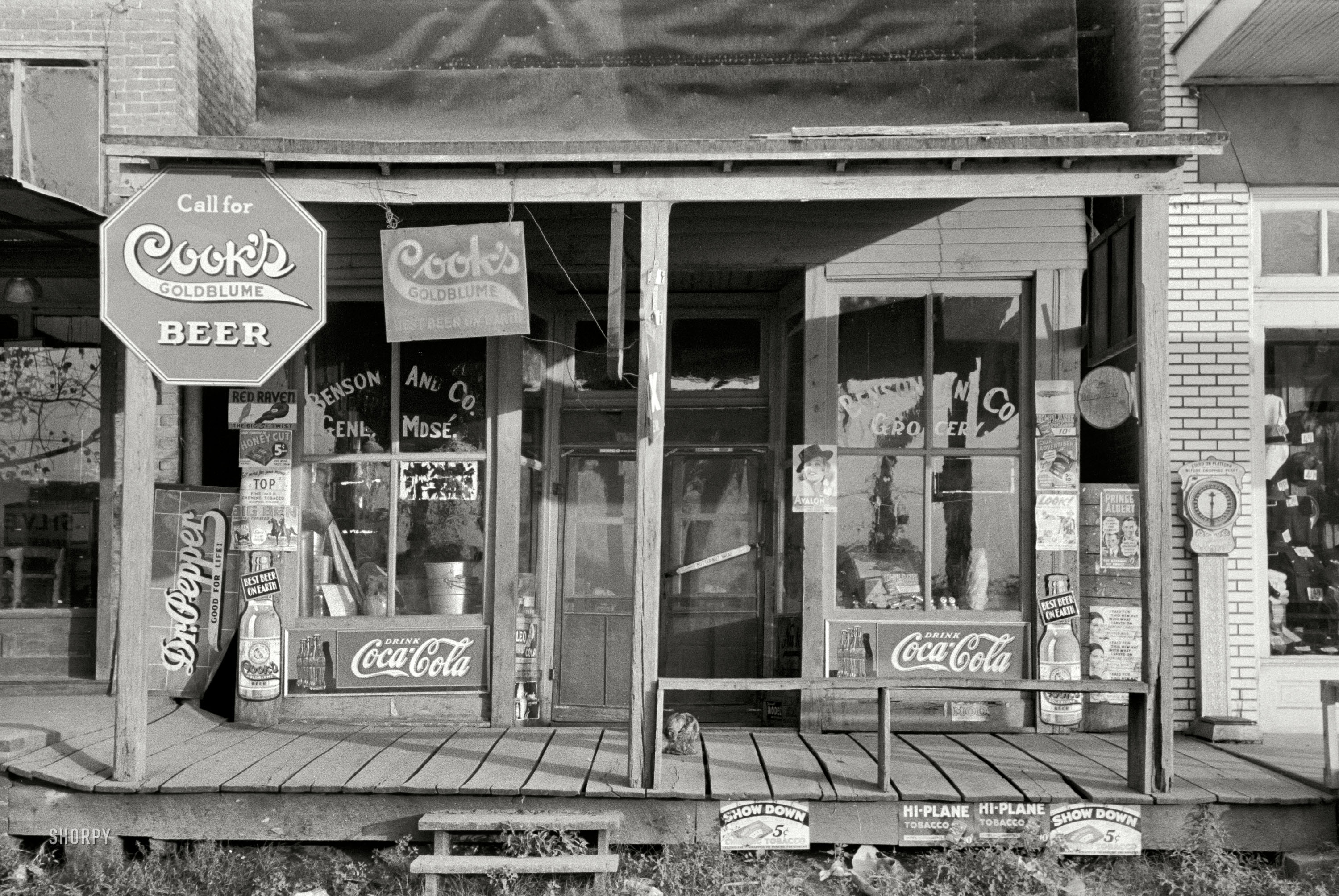 September 1938. "Storefront in Altheimer, Arkansas." Lately I've been inspecting every new post for cats. I am pretty sure this has only the one. 35mm nitrate negative by Russell Lee for the Farm Security Administration. View full size.