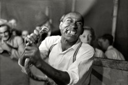 November 1938. "Man chewing piece of snake which he has just bitten off. State fair sideshow in Donaldsonville, Louisiana." 35mm nitrate negative by Russell Lee for the Farm Security Administration. View full size.