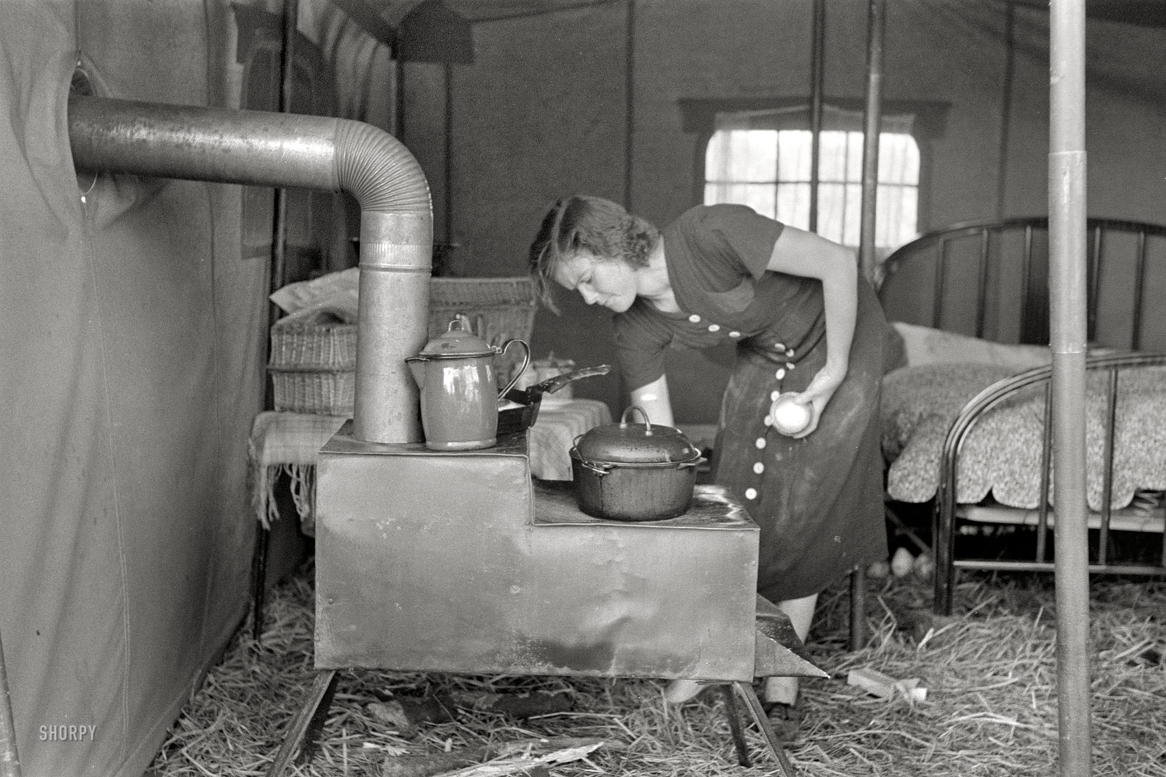 October 1938. "Tent of migrant stove maker and repairer on U.S. 90 near Jeanerette, Louisiana." Photo by Russell Lee for the FSA. View full size. 