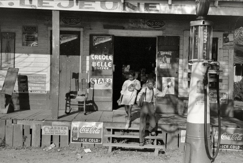 November 1938. Mix, Louisiana. "Negro children coming out of store on their way to school. Note lunches which they are carrying." 35mm nitrate negative by Russell Lee for the Farm Security Administration. View full size.
