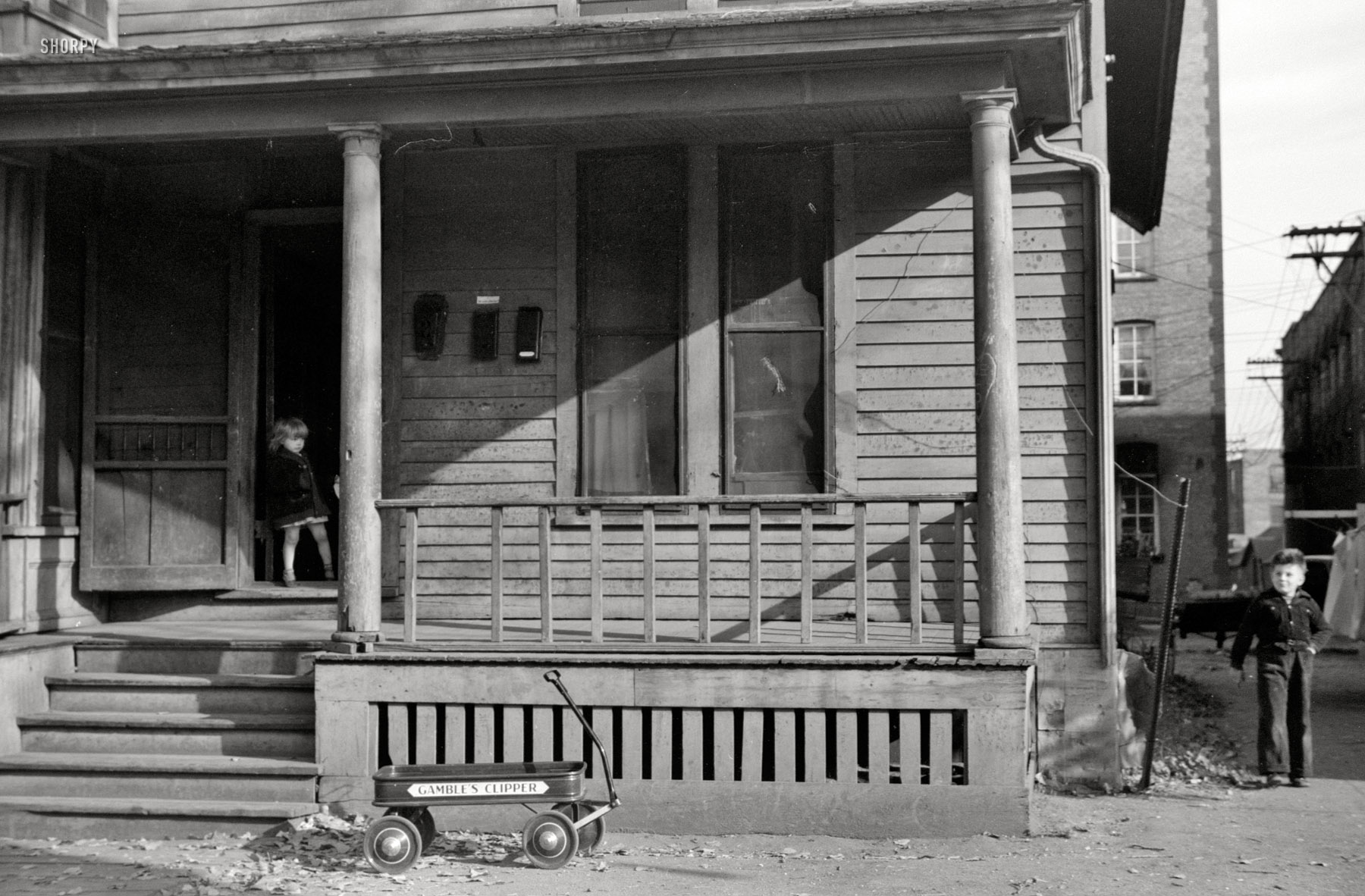 Fall 1940, somewhere in the Midwest. An uncaptioned shot by John Vachon with neighboring 35mm frames taken in Fargo, North Dakota, and Little Falls, Minnesota. We'll just wait for these kids to fill in the details. View full size.