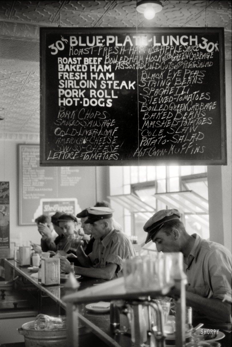 June 1940. Washington, D.C. "In the cafe at a truck drivers' service station on U.S. 1." The truck stop menu starring "Blue Plate Lunch," with cameos by Dr. Pepper and Cold Liver Loaf. 35mm negative by Jack Delano. View full size.
