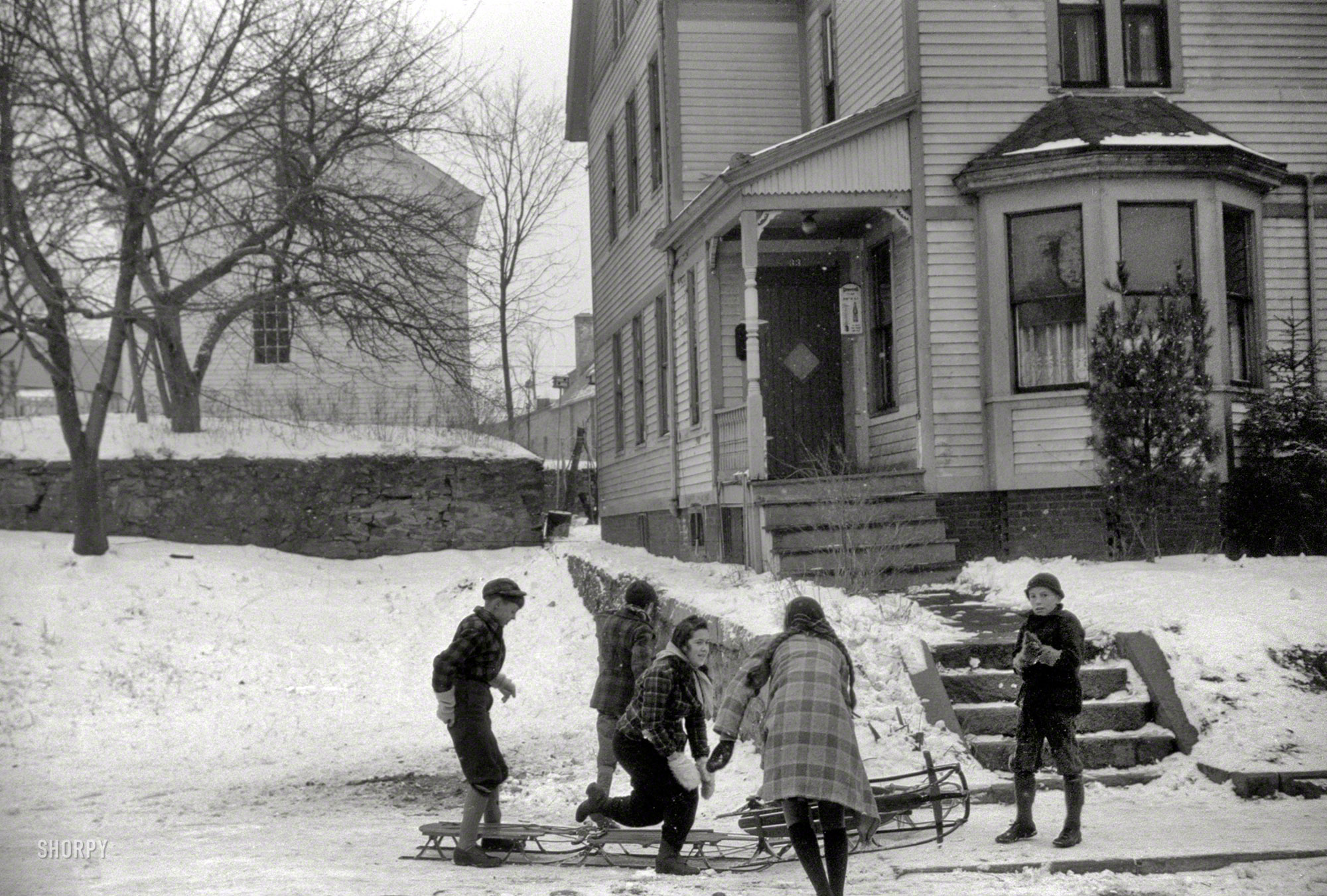 November 1940. "Children sledding, Jewett City, Connecticut." First stop: the frozen flagpole. 35mm nitrate negative by Jack Delano. View full size.