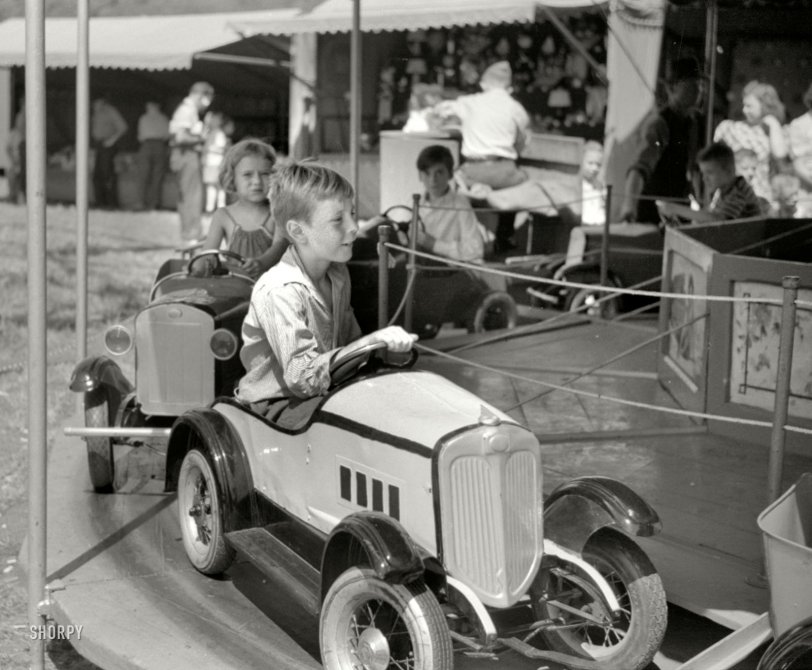 October 1941. "At a small American Legion carnival just outside Bellows Falls, Vermont." Left turn only. 35mm nitrate negative by Jack Delano. View full size.