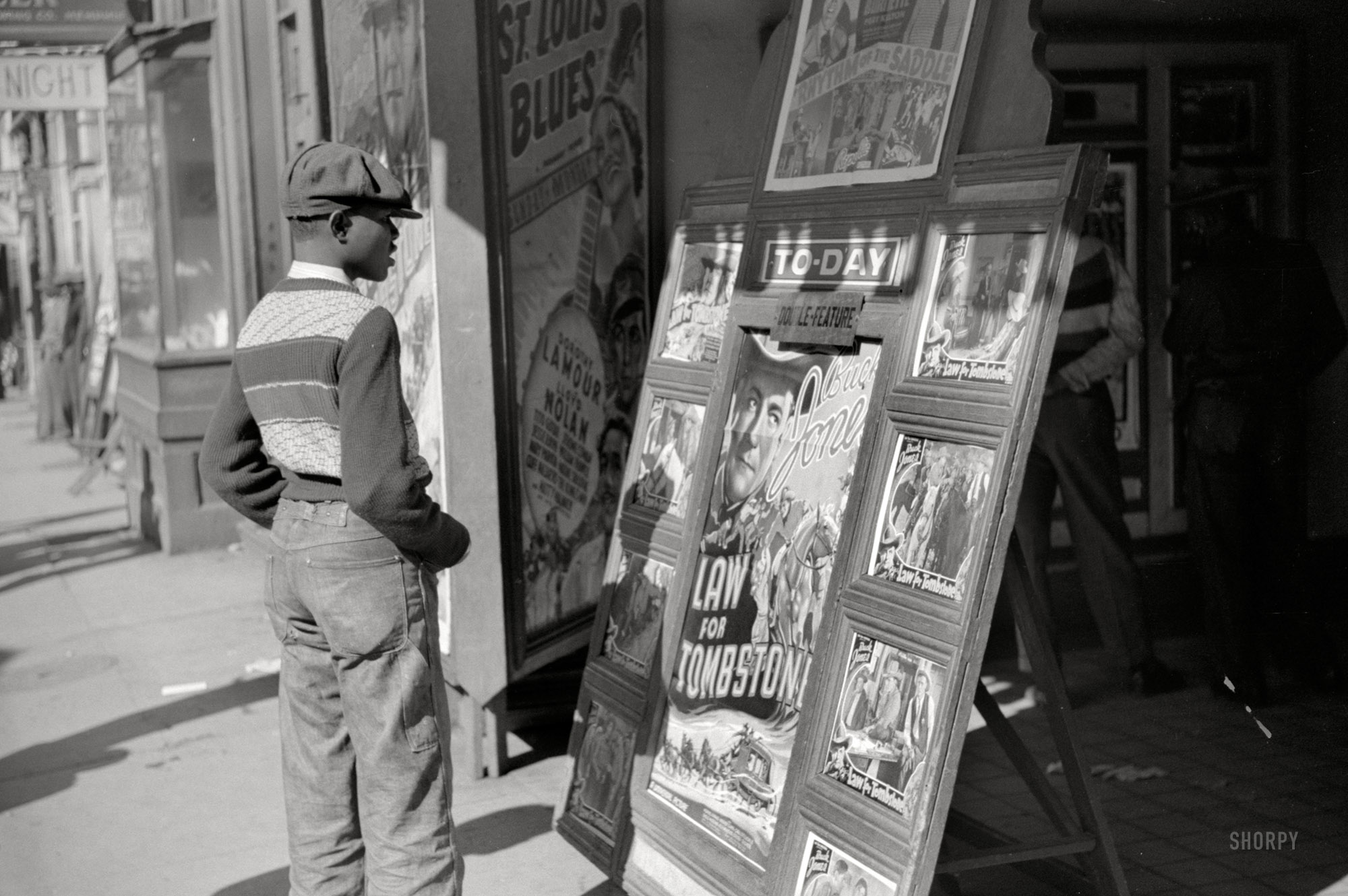 October 1939. Memphis, Tennessee. "Entrance to a movie house on Beale Street." The double feature: "Rhythm of the Saddle" and Buck Jones in "Law for Tombstone." 35mm nitrate negative by Marion Post Wolcott. View full size.