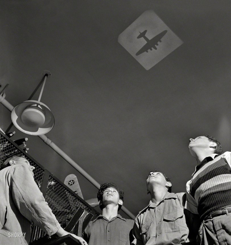 &nbsp; &nbsp; &nbsp; &nbsp; Flying saucer at 9 o'clock!
July 1942. "Training high school boys to identify planes. There's no question about these young people's ability to recognize airplanes by their silhouettes. They're learning this and other essential facts of aviation at Weequahic High School, Newark, New Jersey, in a course designed to teach students the fundamentals of flying." Office of War Information photo. View full size.
