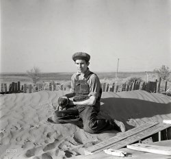 March 1936. "Farmer's son playing on one of the large soil drifts which threaten to cover up his home. Liberal, Kansas." Medium-format nitrate negative by Arthur Rothstein for the Resettlement Administration. View full size.