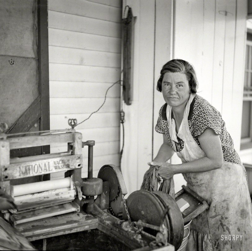 May 1936. "Wife of farmstead farmer. Kearny, Nebraska." Thanks to my National Vacuum Washer, I barely have to lift a finger come laundry day! Or maybe not. Photo by Arthur Rothstein, Farm Security Administration. View full size.

