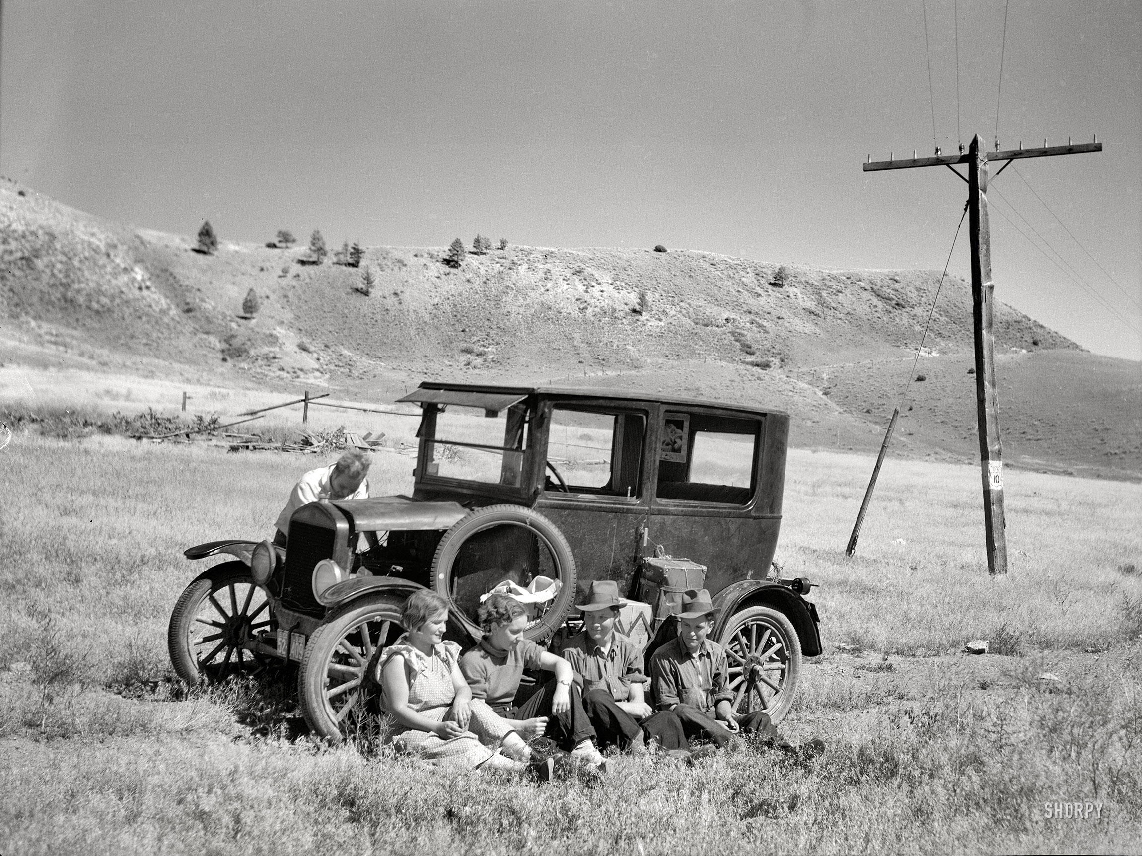 July 1936. "Vernon Evans and family of Lemmon, South Dakota, near Missoula, Montana, Highway 10. Leaving the grasshopper-ridden and drought-stricken area for a new start in Oregon and Washington. Make about 200 miles a day in Model T Ford." Our second glimpse of these travelers, last seen here. Medium-format negative by Arthur Rothstein, Resettlement Administration. View full size.