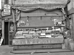 April 1938. "Fruit stand in Washington, D.C." A smattering of citrus and yes, they have bananas. Medium format nitrate negative by John Vachon. View full size.