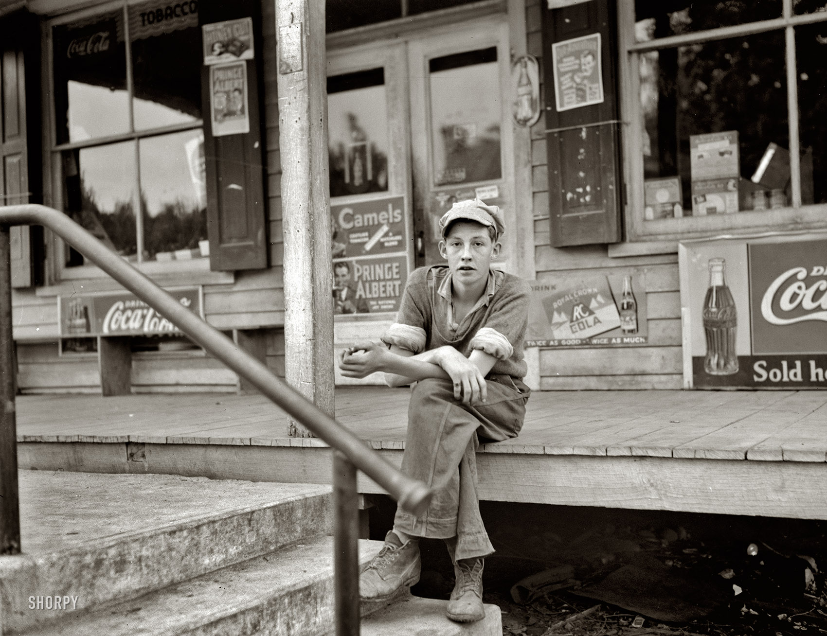 April 1938. "Boy on porch of general store. Roseland, Virginia." Medium-format negative by John Vachon for the Resettlement Administration. View full size.