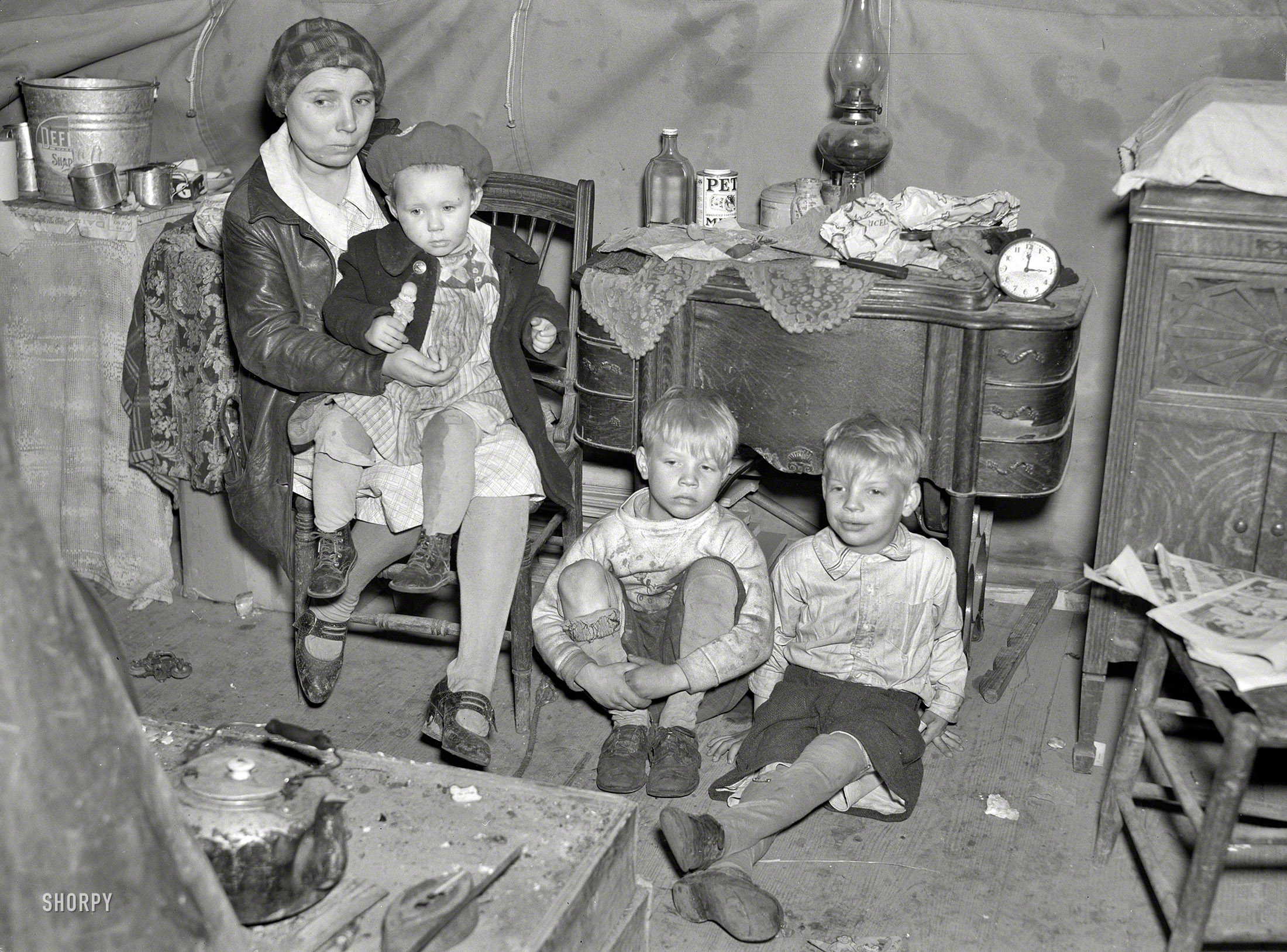 April 1937. "Flood refugee family in tent at Tent City near Shawneetown, Illinois." Photo by Russell Lee for the Resettlement Administration. View full size.