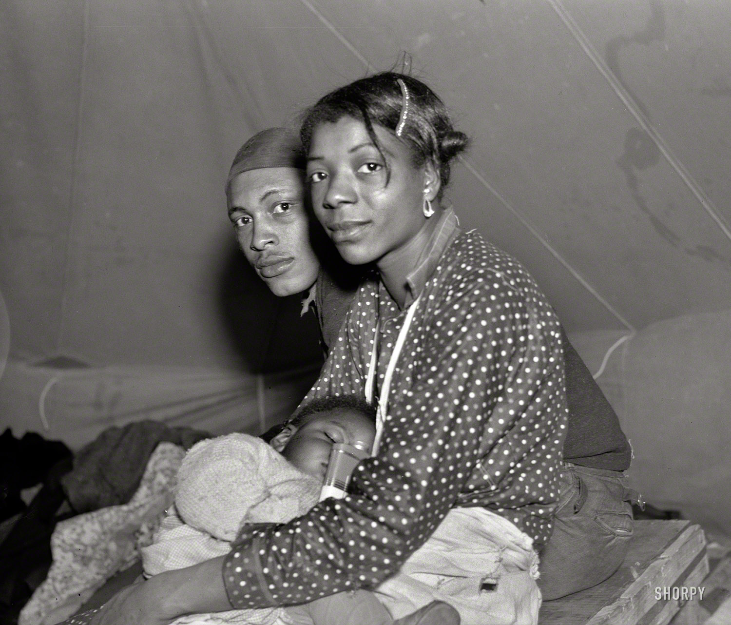 Feb. 1937. "Refugees from the 1937 flood in their tent of the camp in Marianna, Arkansas." Photo by Edwin Locke, Resettlement Administration. View full size.