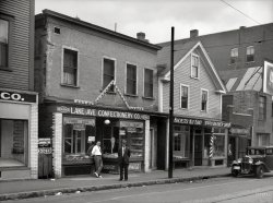 August 1937. "Street in Manchester, New Hampshire." The Merchants of Manchester. Medium-format nitrate negative by Edwin Locke. View full size.