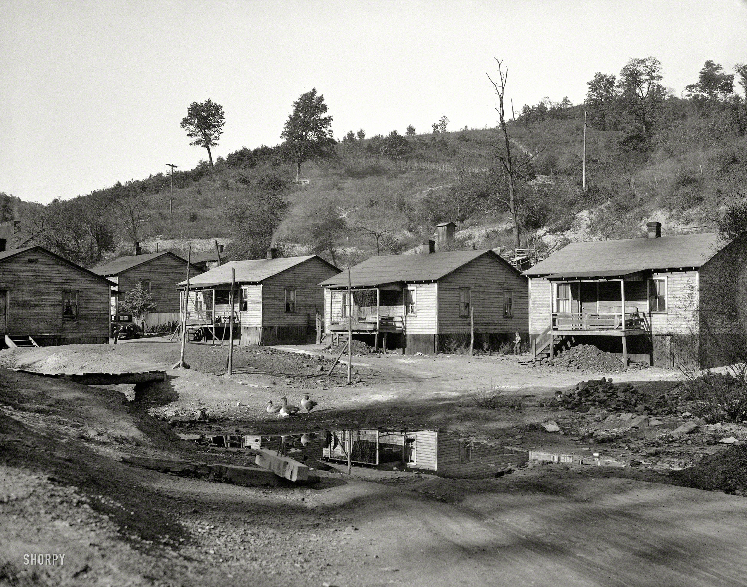 1935. "Miner's house at Scott's Run, West Virginia. Note sewerage system." Photo by Elmer Johnson for the Resettlement Administration. View full size.