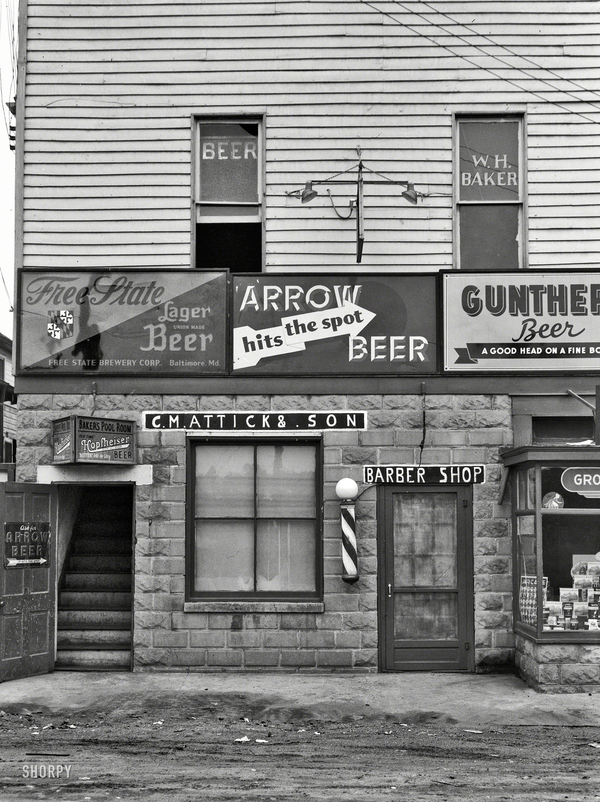 Sept. 1937. "Barber shop and pool hall. Berwyn, Maryland." Between rounds, you can get a haircut. Medium-format negative by John Vachon. View full size.