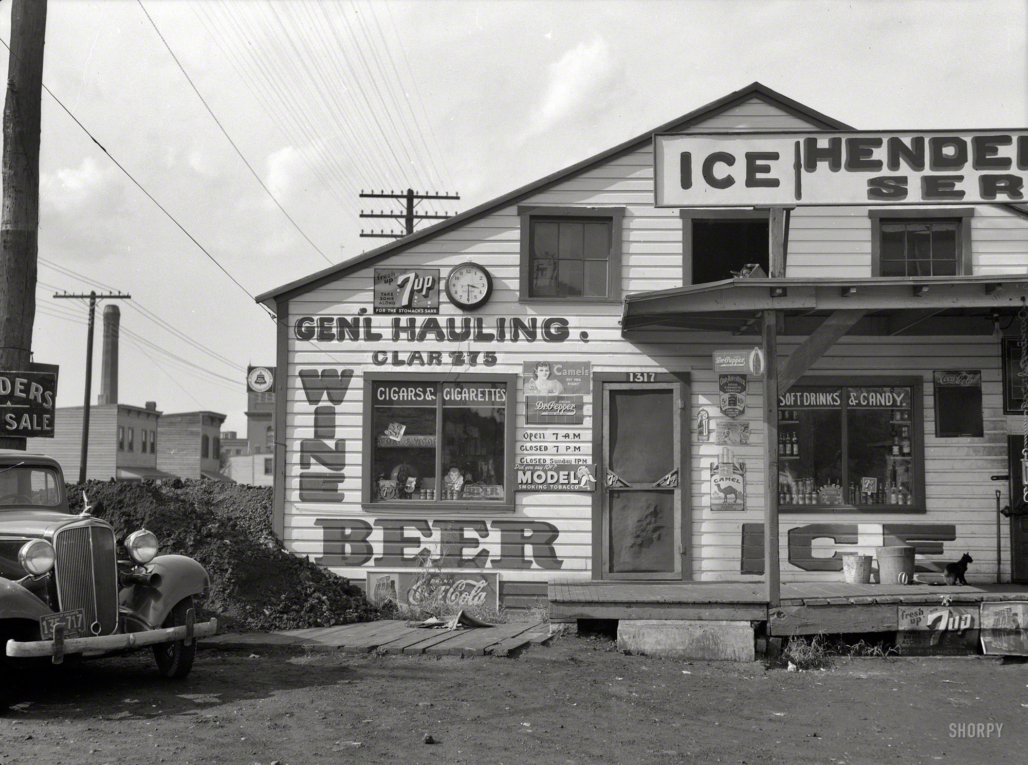 September 1937. "Icehouse. Rosslyn, Virginia." Just across the Potomac from Washington, the home of beer, wine and 7-Up from 7 to 7, as well as one cool cat. Medium-format nitrate negative by John Vachon. View full size.