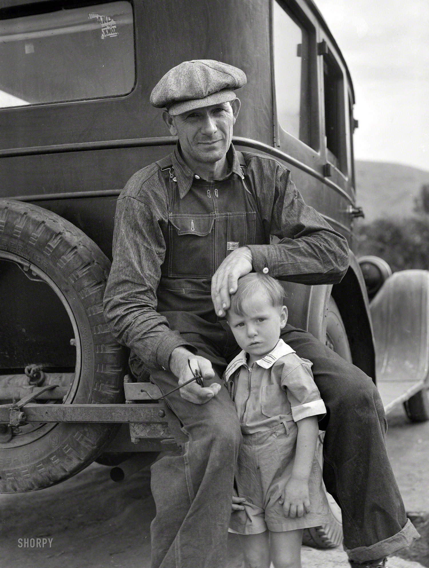 November 1936. "Drought refugee from Polk, Missouri. Awaiting the opening of orange picking season at Porterville, California." Photo by Dorothea Lange for the Resettlement Administration. View full size.