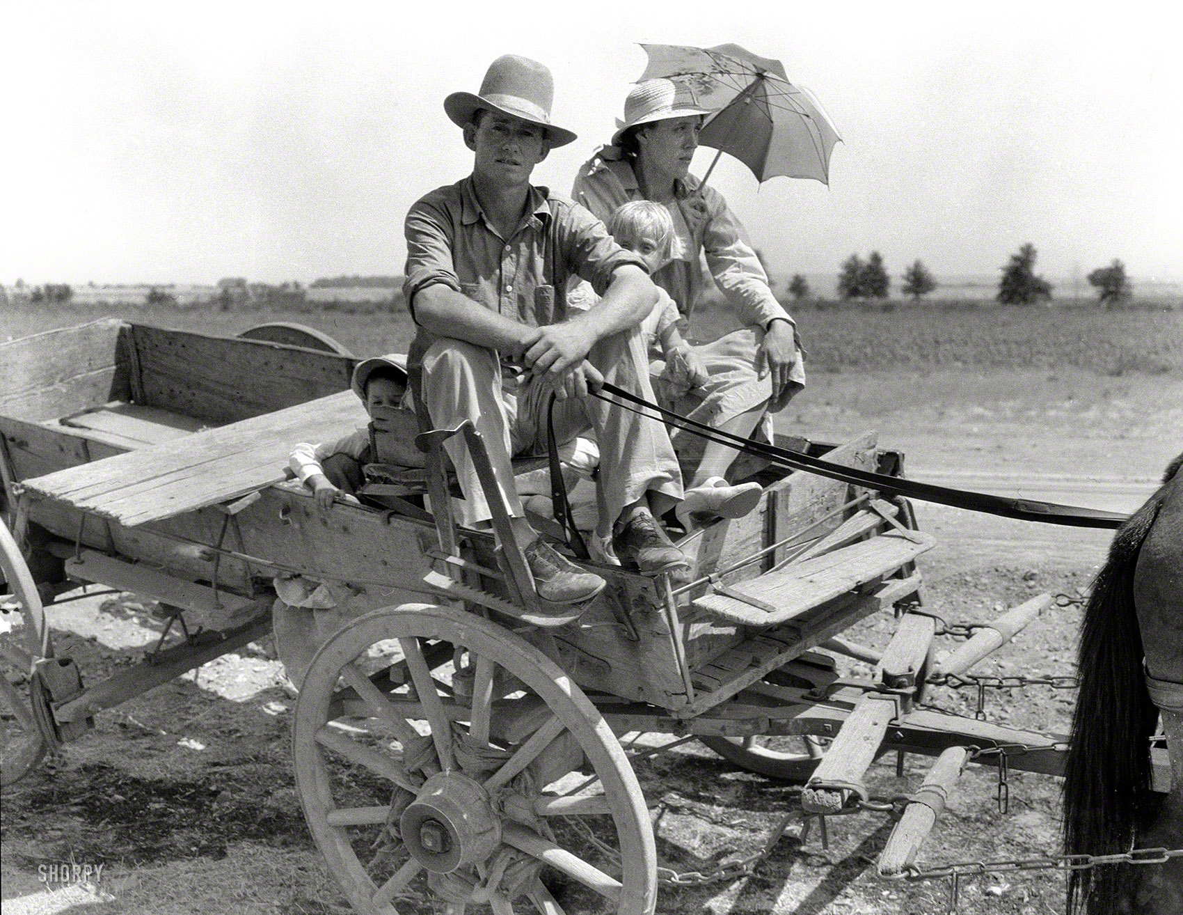 August 1939. "Drought-stricken farmer and family near Muskogee, Oklahoma. Agricultural day laborer." Wanted: Escalade with tinted glass. Large format negative by Dorothea Lange, Resettlement Administration. View full size.