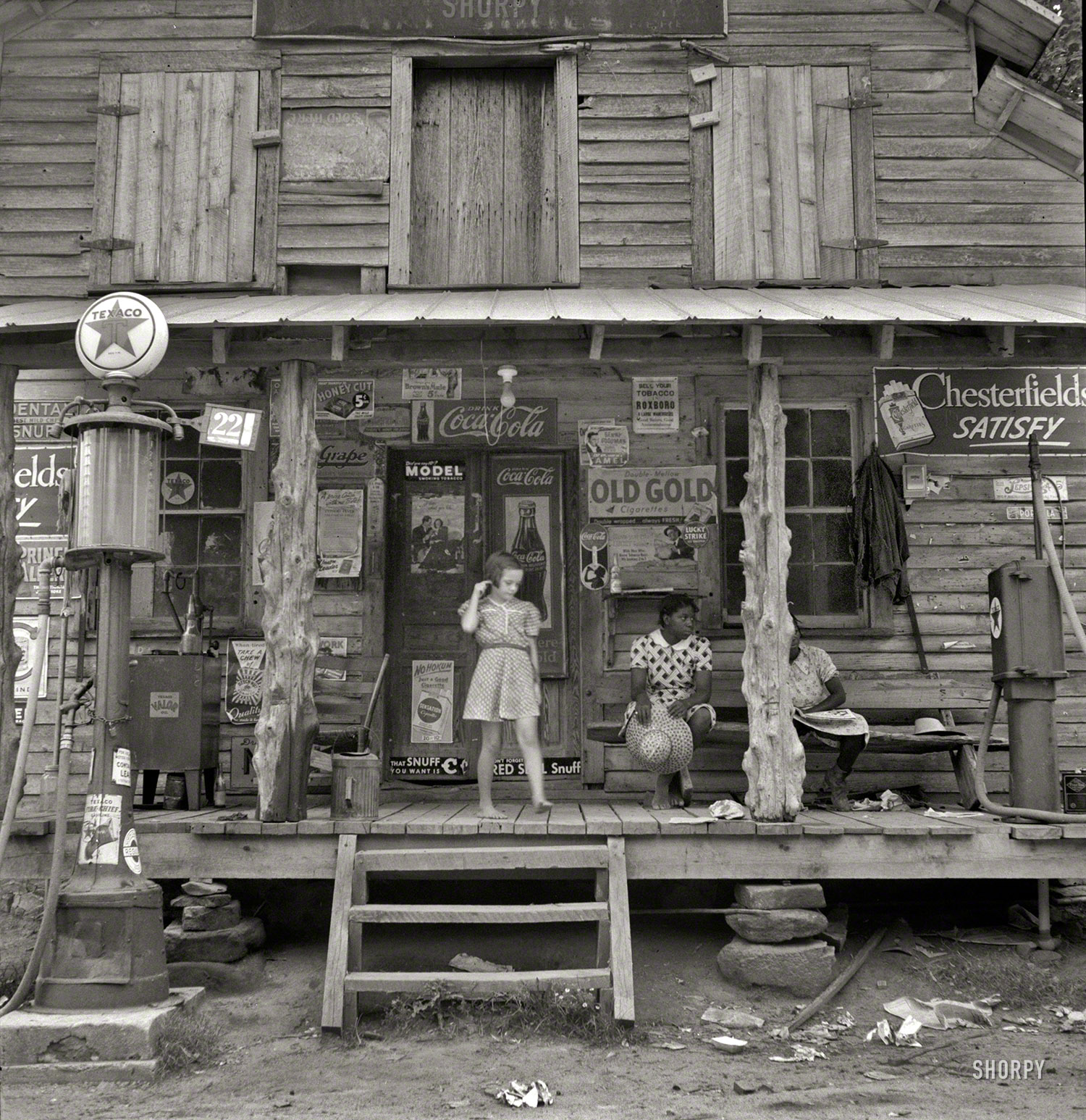 July 1939. "Daughter of white tobacco sharecropper at country store. Person County, North Carolina." The rustic emporium seen earlier here and here. Medium-format nitrate negative by Dorothea Lange. View full size.