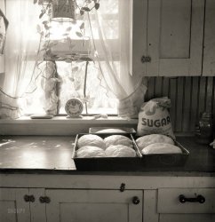 August 1939. "A corner of the T.P. Schrock kitchen in their new home. Yakima Valley, Wash." Putting the yeast in yesterday, which would  be only "erdy" without it. Photo by Dorothea Lange, Resettlement Administration. View full size.