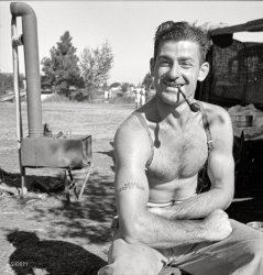 August 1939. "Oregon. Unemployed lumber worker goes with his wife to the bean harvest. Note Social Security number tattooed on his arm." The jolly fellow seen here a few years back. Photo by Dorothea Lange. View full size.