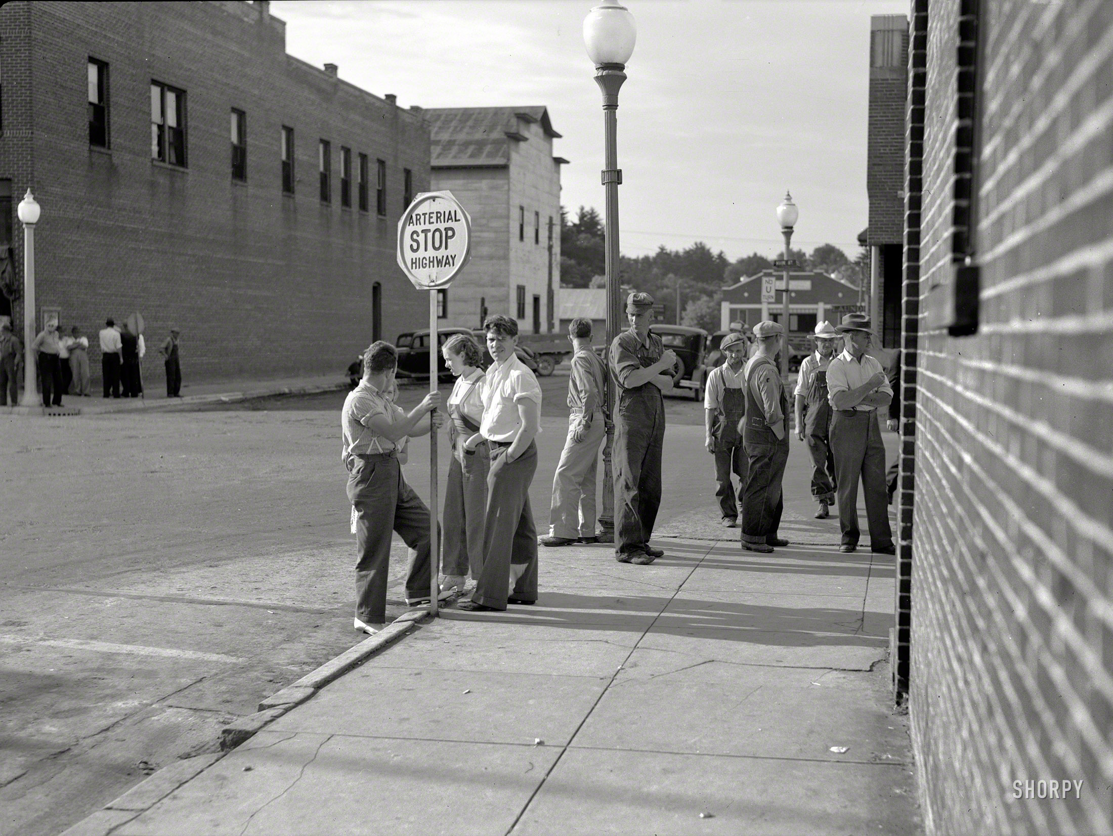 June 1937. "Street corner. Black River Falls, Wisconsin." Medium format negative by Russell Lee for the Resettlement Administration. View full size.