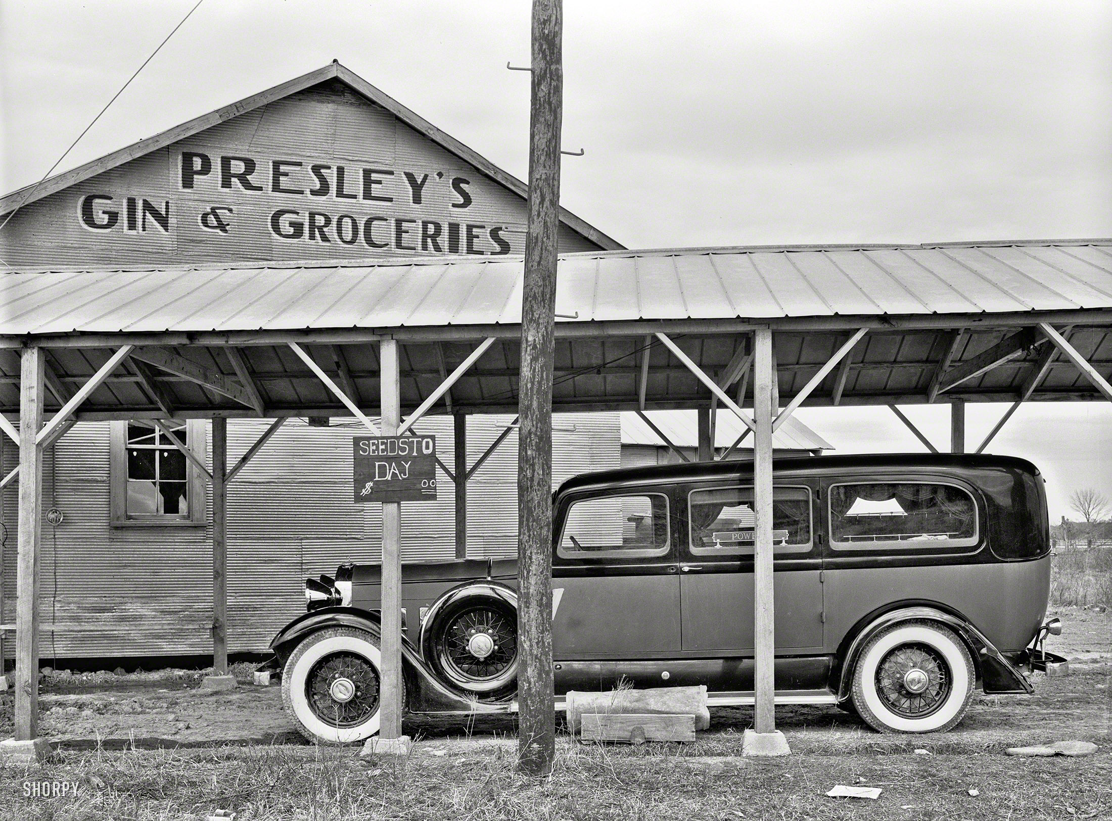 January 1939. "Funeral ambulance parked under gin shed. Mound Bayou, Mississippi." Photo by Russell Lee, Farm Security Administration. View full size.