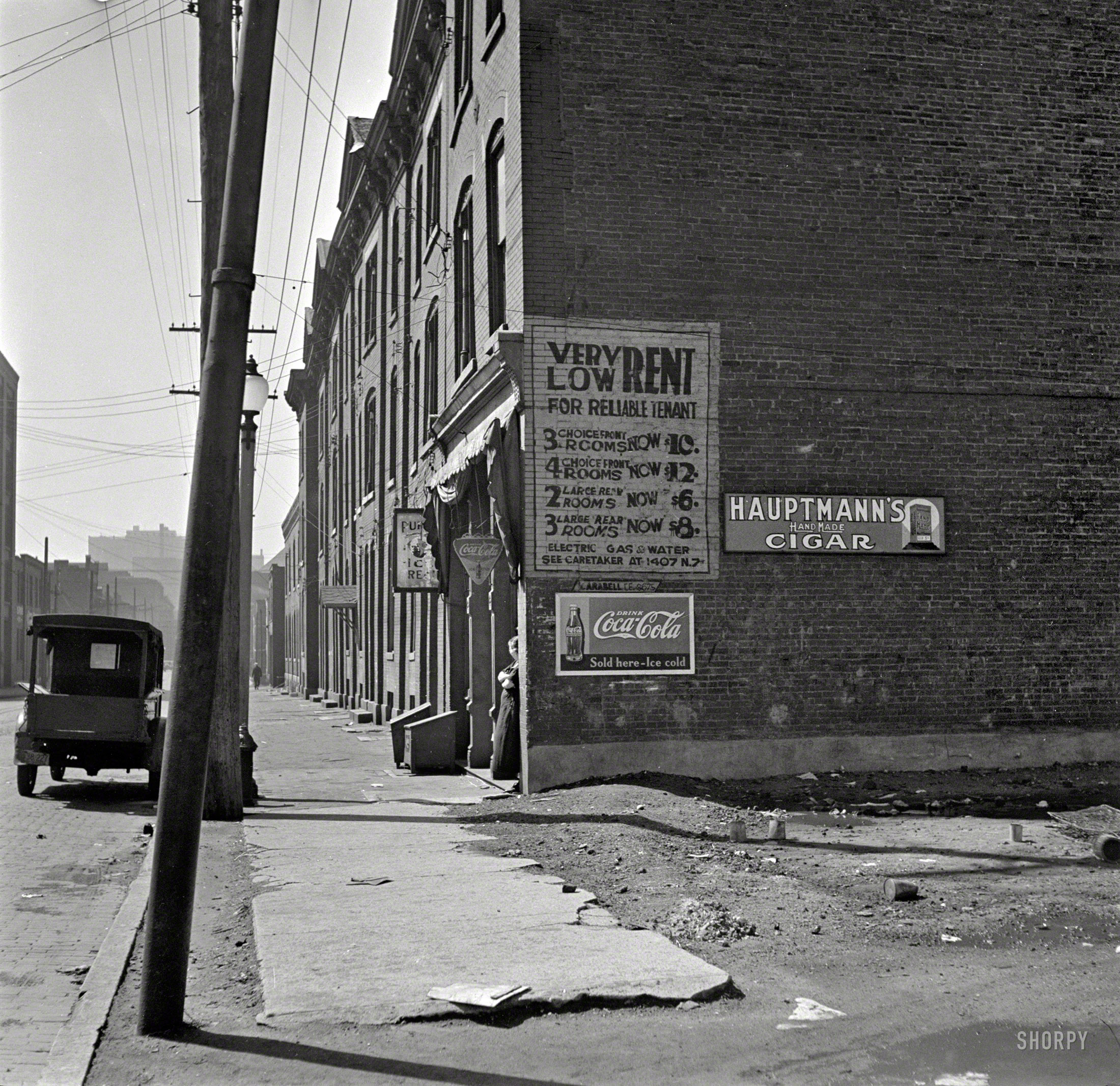 March 1936. "Low-cost housing. Saint Louis, Mo." Cigars and Coke not included. Photo by Arthur Rothstein for the Resettlement Administration. View full size.