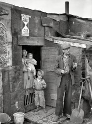 January 1939. "Herrin, Illinois. Family on relief living in shanty at city dump." Photo by Arthur Rothstein for the Resettlement Administration. View full size.