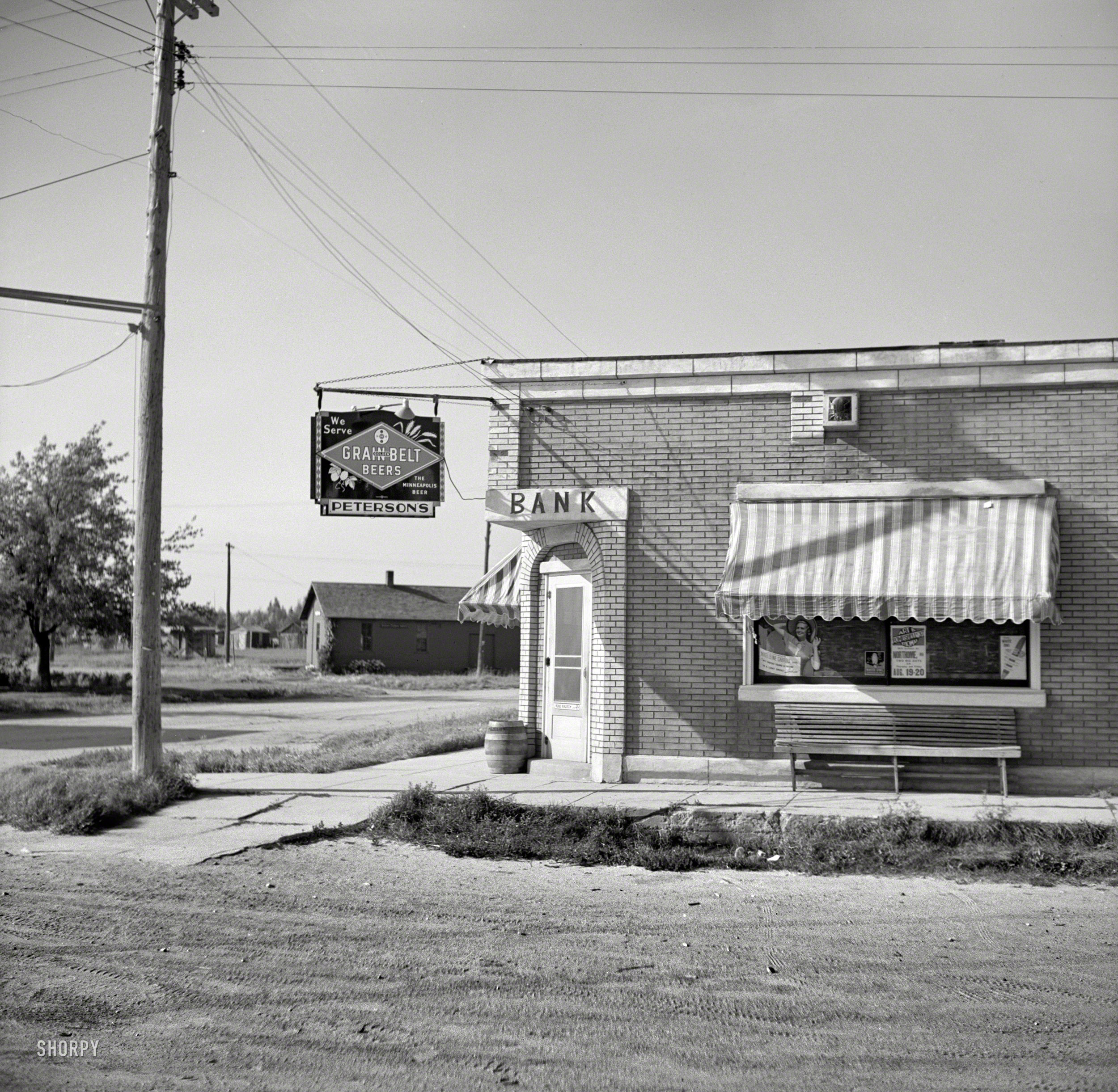 August 1937. "Former bank, now a saloon. Mizpah, Minnesota." Medium format negative by Russell Lee for the Farm Security Administration. View full size.