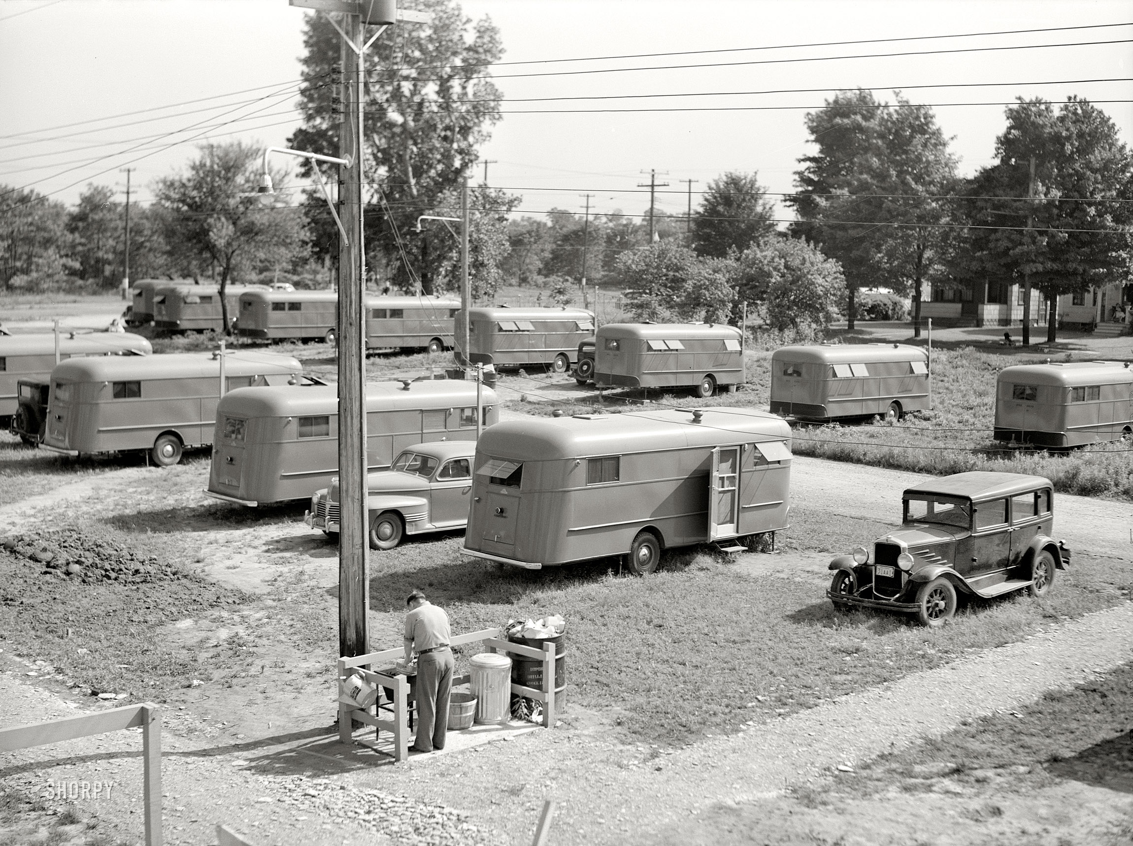June 1941. Erie County, Pennsylvania. "Each group of ten trailers in the FSA camp at Erie has a trailer service unit, water faucet, slop sink, and garbage pail." Photo by John Vachon for the Farm Security Administration. View full size.