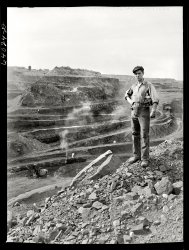 August 1941. "One end of the Hull-Rust-Mahoning pit, largest open pit iron mine in the world, near Hibbing, Minnesota. The pit is two and a half miles long, three quarters of a mile wide and about four hundred feet deep." Medium format safety negative by John Vachon for the Farm Security Administration. View full size.