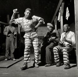 May 1941. "In the convict camp at Greene County, Georgia." The guitarist is bluesman Buddy Moss. Photo by Jack Delano. View full size.