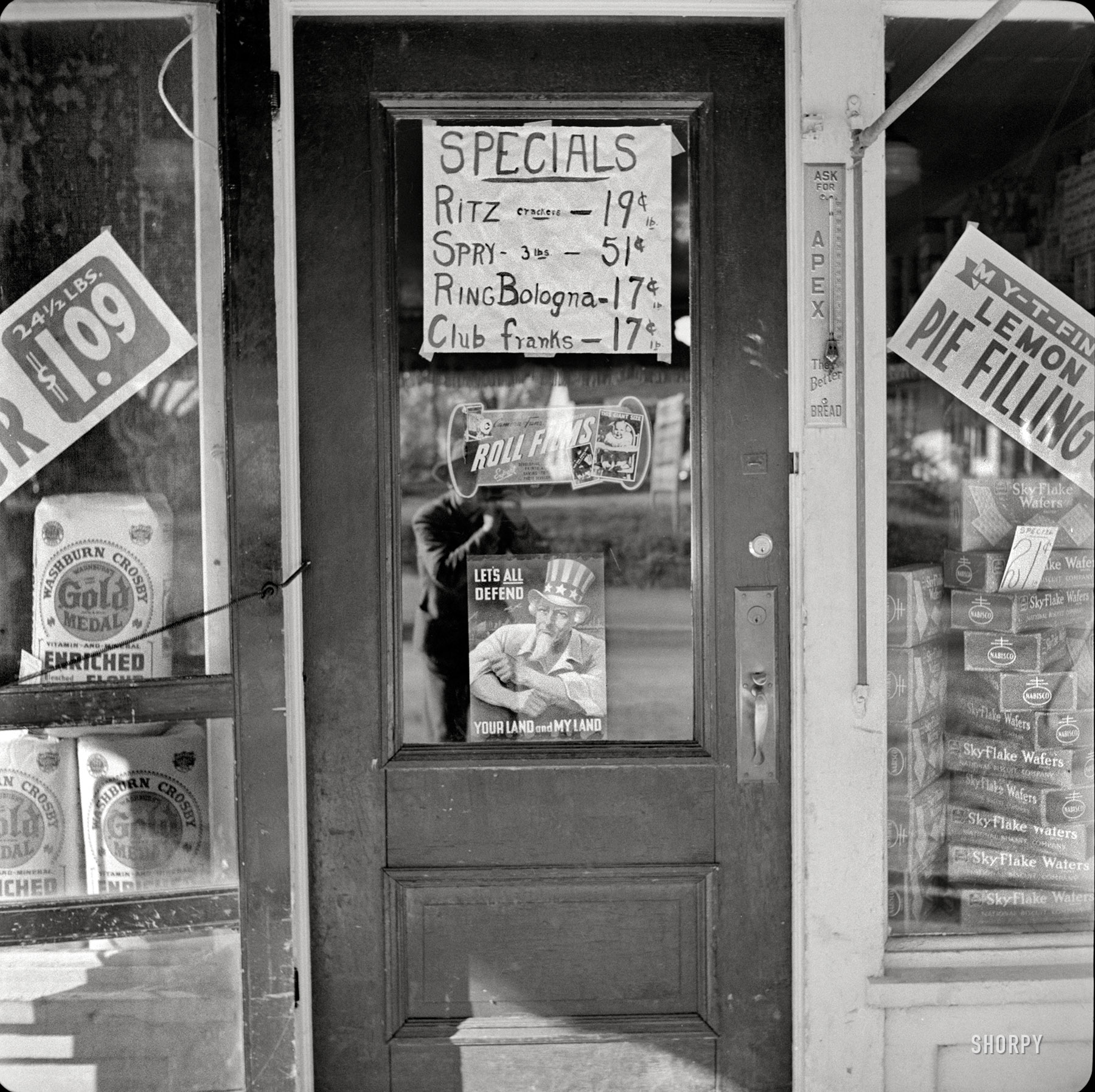 October 1941. "Grocer's doorway in Vernon, New York." Special appearance by John Collier. Medium-format nitrate negative. View full size.