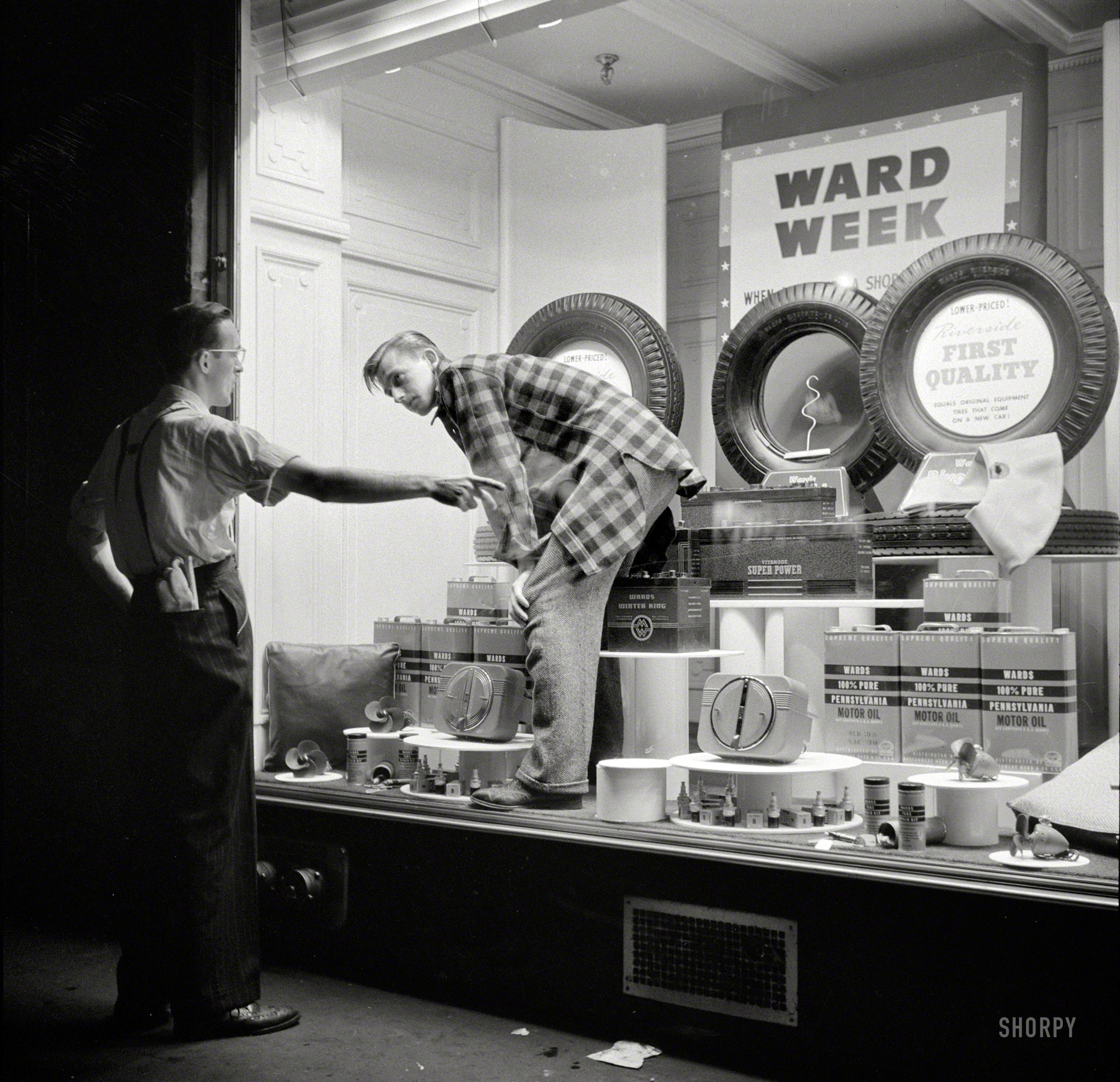 October 1941. "Dressing window in Amsterdam, New York." The art of auto parts and accessories. Photo by John Collier. View full size.