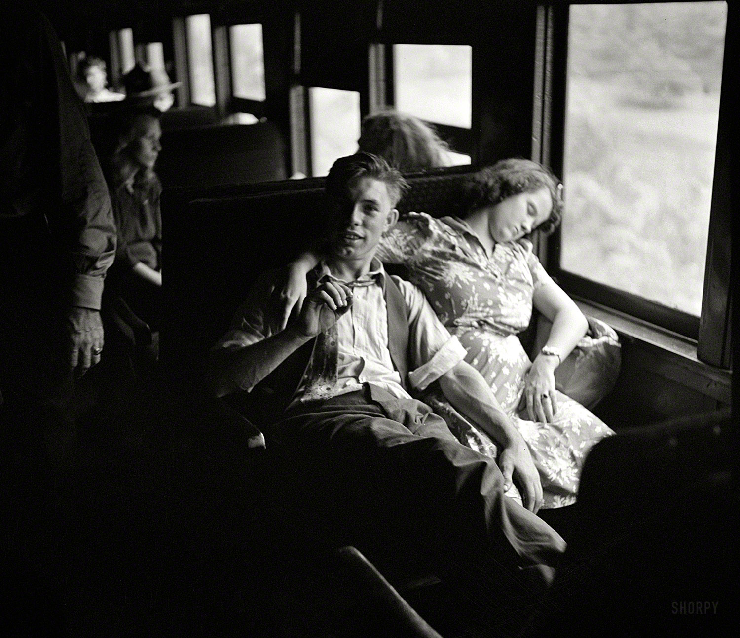 &nbsp; &nbsp; &nbsp; Two of some 300 West Virginians recruited by the Farm Security Administration to travel to Upstate New York for the fall harvest of peaches, apples, tomatoes and other crops, part of a "Food for Victory" campaign occasioned by the wartime manpower shortage.
September 1942. "High school boys and girls going by special train from Richwood, West Virginia, to upper New York state to help bring in the harvest." Photo by John Collier for the Farm Security Administration. View full size.