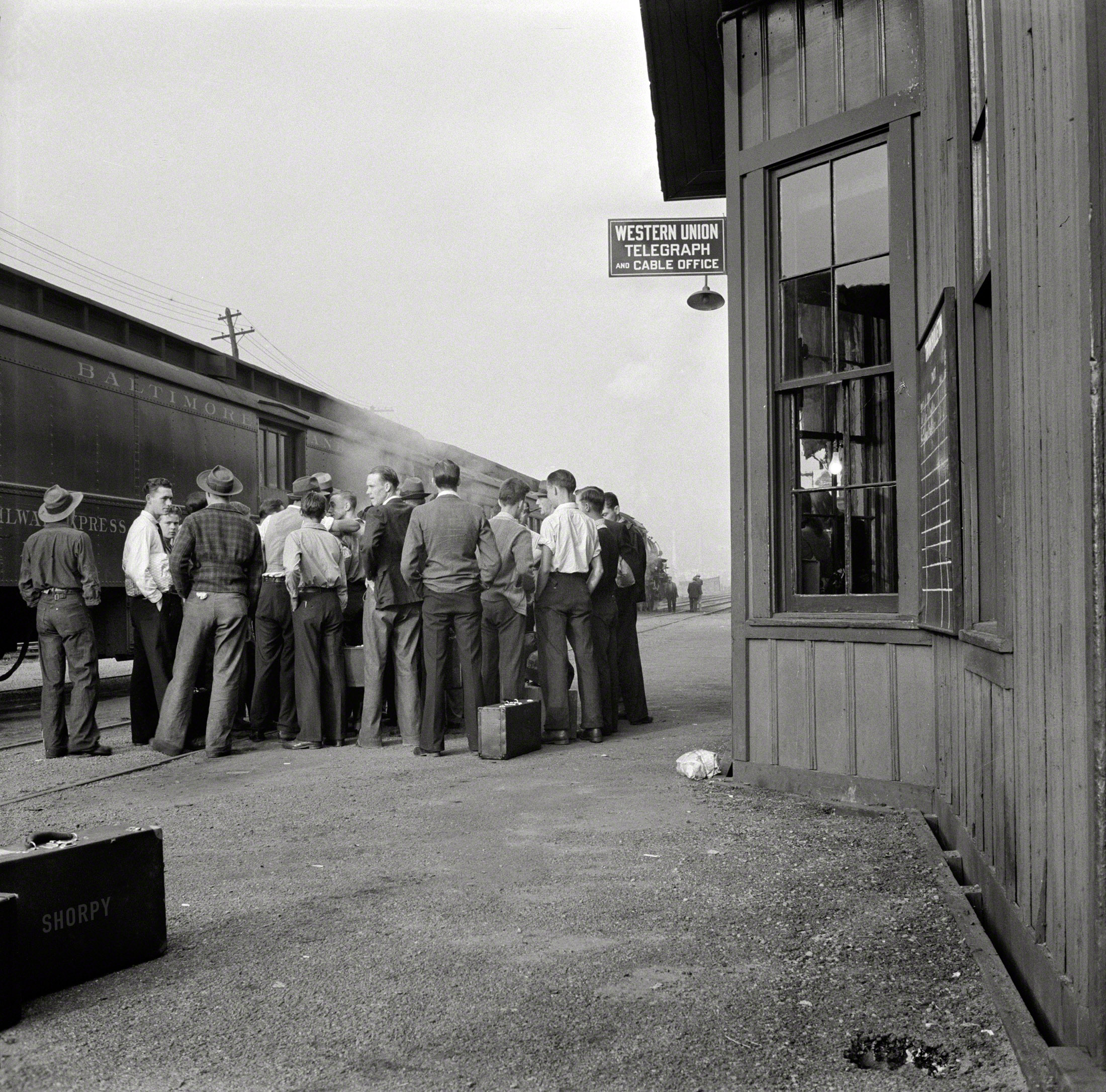 September 1942. "Richwood, W. Va. Station scene at departure of men to help in the harvest in upstate New York." Photo by John Collier. View full size.