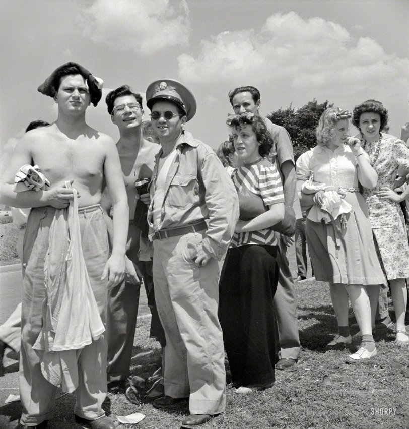 July 1942. Washington, D.C. "On Sunday people wait as long as one hour to get into the municipal swimming pool." In the meantime, buddy, keep your shirt on. Photo by Marjory Collins for the Office of War Information. View full size.
