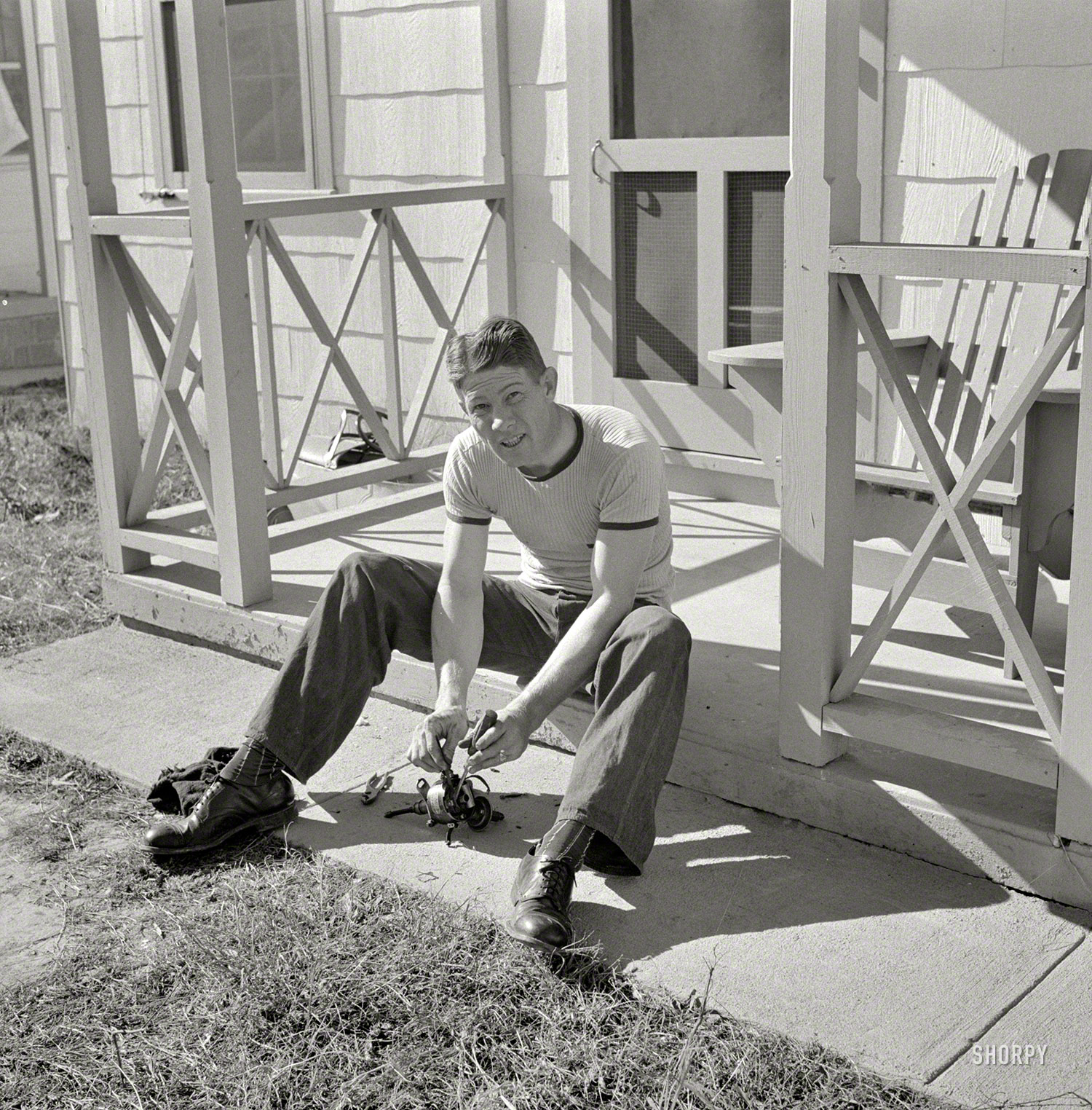 October 1941. "Radford, Virginia. Sunset Village, Farm Security Administration housing project. Fred B. Williams from Savannah, Georgia, cleaning car distributor on the porch of his home, 803 9th Street." Medium format nitrate negative by Marion Post Wolcott. View full size.