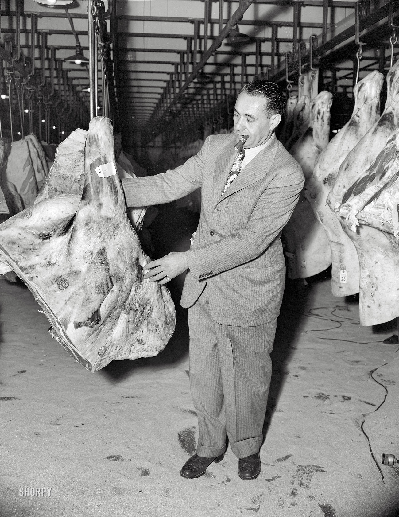 July 1943. "Examining meat in a wholesale meat market. A reconstruction photographed during the filming of Black Marketing, a motion picture produced by the U.S. Office of War Information." Photo by Roger Smith. View full size.