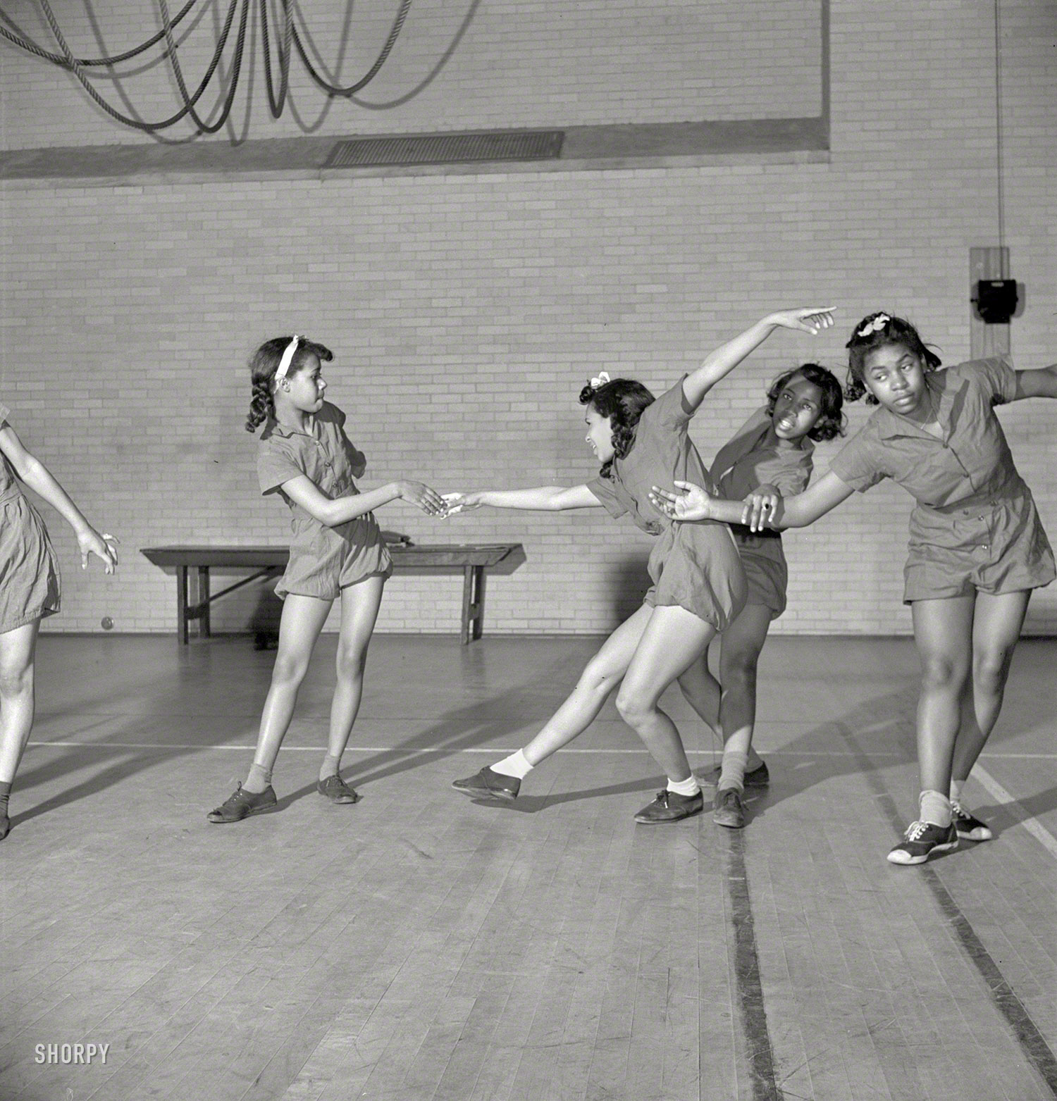 March 1942. Washington, D.C. "Dancing class at an elementary school." Expert instruction in both the boogie and the woogie. Medium format nitrate negative by Marjory Collins for the Office of War Information. View full size.