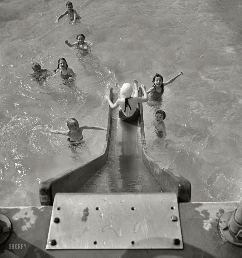 May 1942. "Greenbelt, Maryland. A constant stream of water runs down the swimming pool slide." Photo by Marjory Collins. View full size.

