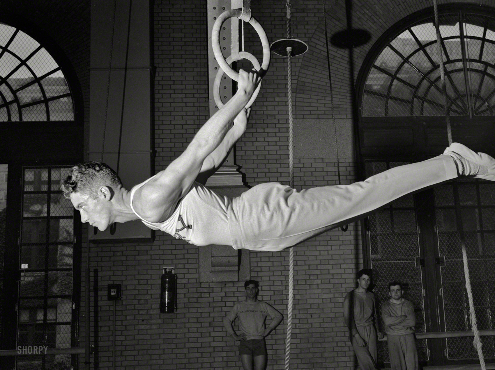 July 1942. "U.S. Naval Academy, Annapolis, Md. Gymnast on the flying rings." Our third look at Navy athletes captured on film by Lt. Whitman. View full size.