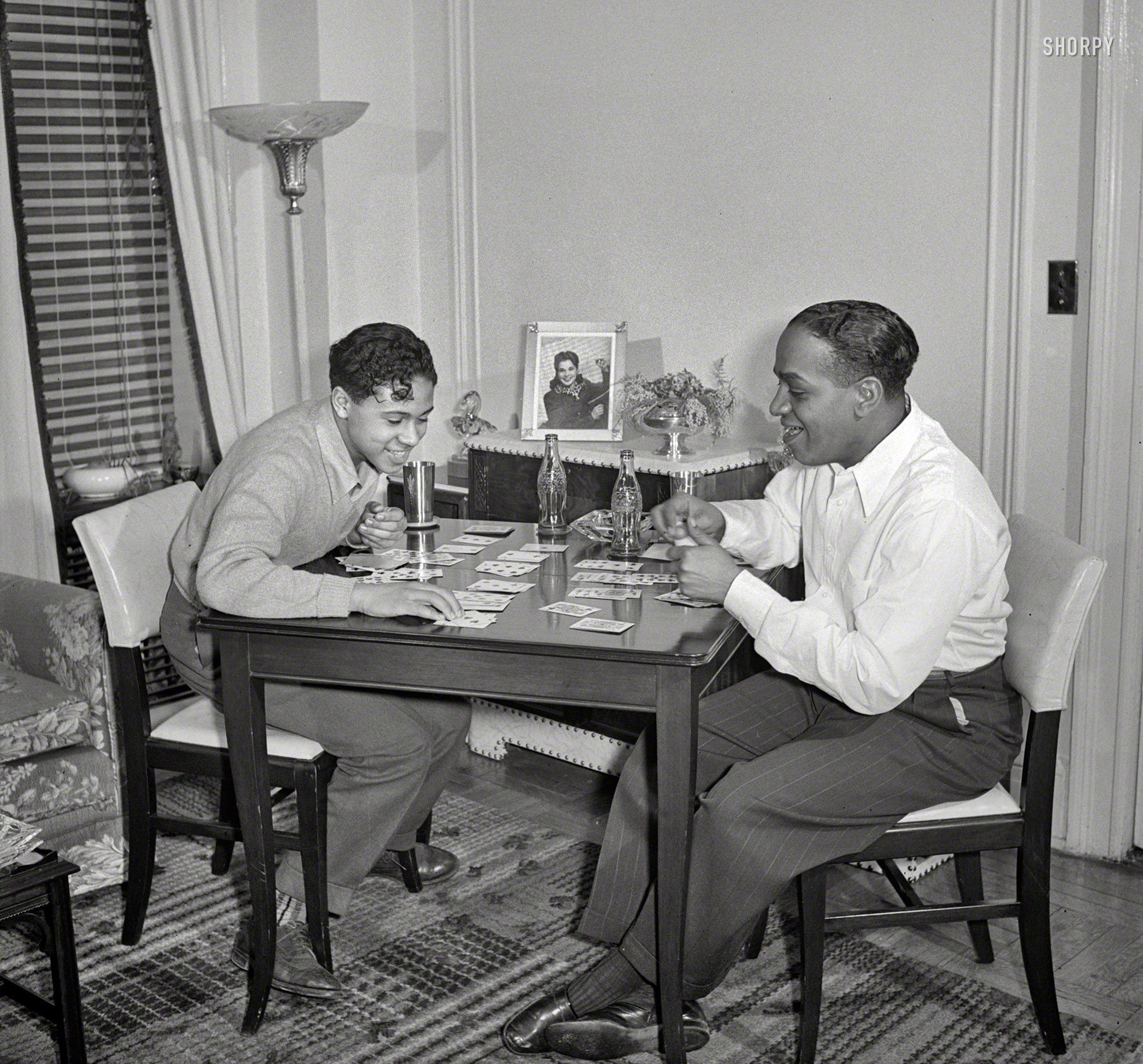Another of Albert Fenn's uncaptioned New York photos from 1942, this one part of a series of pictures showing the violinist and bandleader Eddie South with his family at home. A very tidy home -- note that even the Coke bottles have coasters. Office of War Information archive negative. View full size.