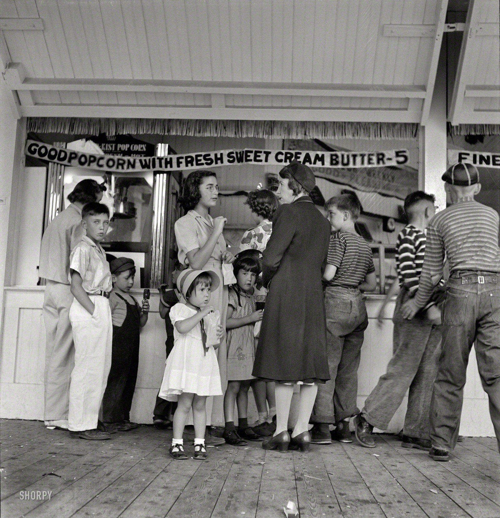 August 1942. "Butte, Montana. Children are transported to Columbia Gardens, an outdoor amusement resort, every Thursday during the summer by city buses." Medium-format nitrate negative by Russell Lee. View full size.