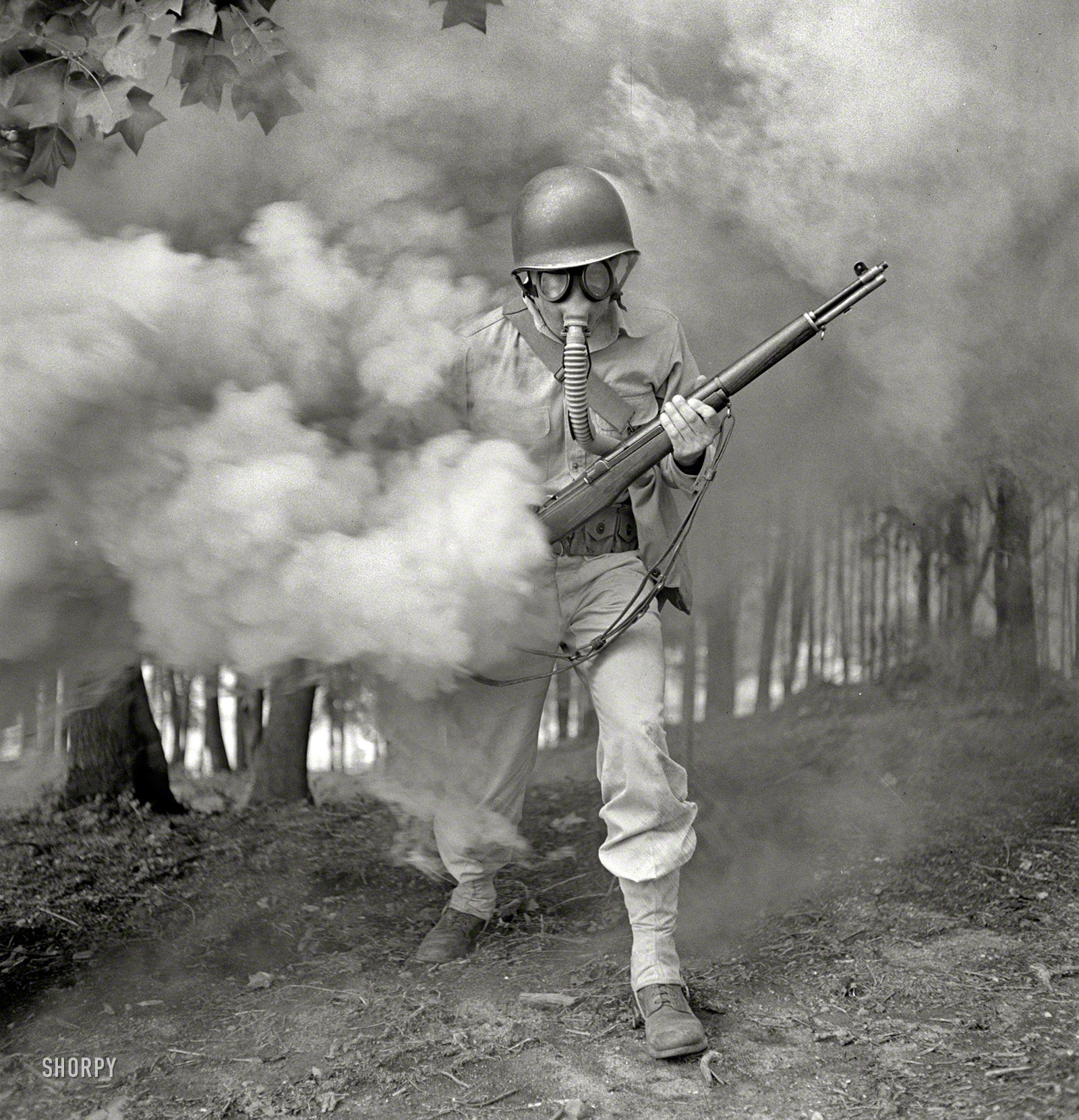 September 1942. "Fort Belvoir, Virginia. Sergeant George Camplair learning how to use a gas mask in a practice smokescreen." Sgt. Camplair in one of his scarier manifestations. (He could have used the mask back when he was peeling onions.) Photo by Jack Delano, Office of War Information. View full size.