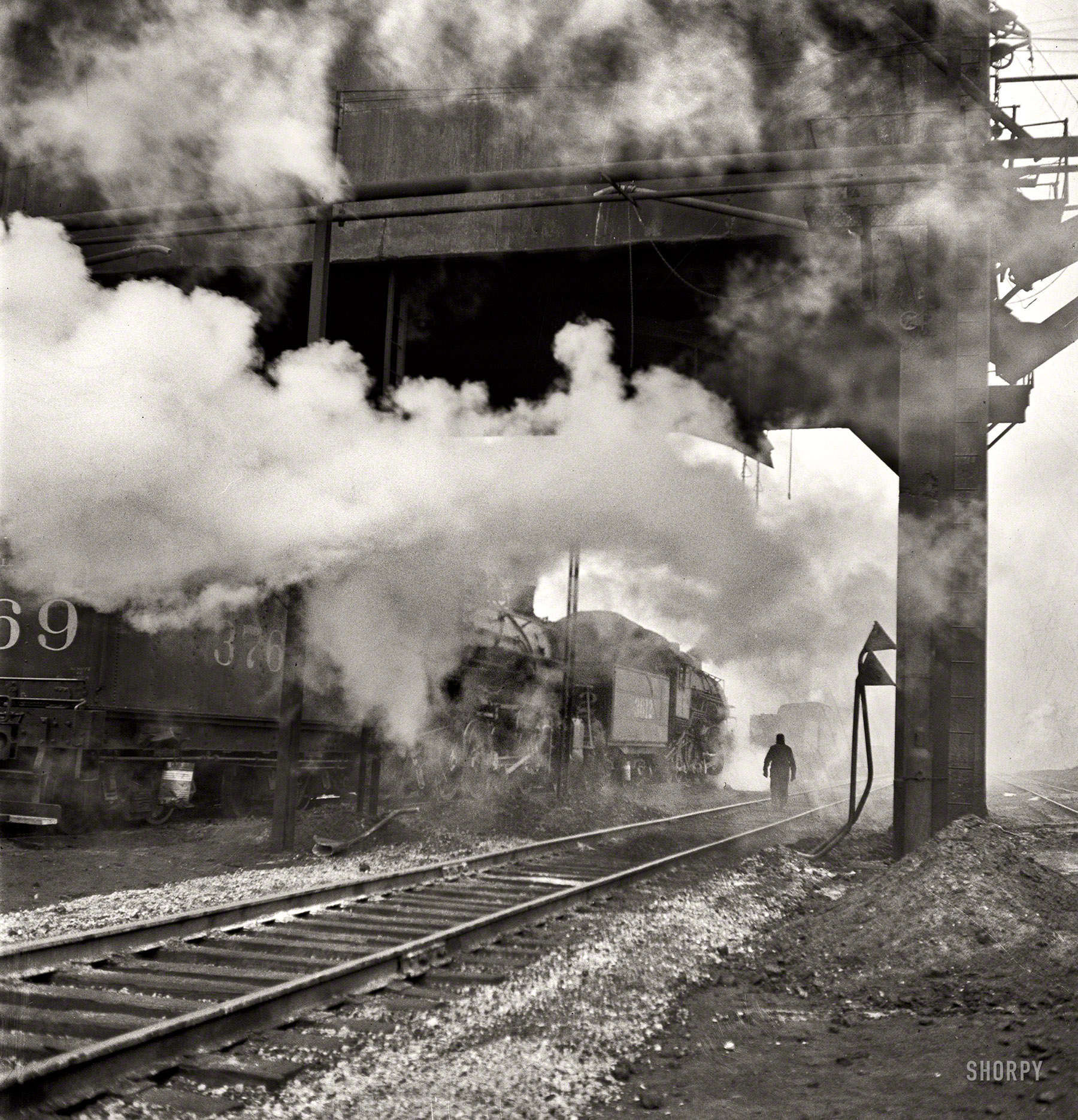 November 1942. "Chicago. Locomotives loading up with coal, water and sand at an Illinois Central Railroad yard before going out on the road." Medium-format negative by Jack Delano for the Office of War Information. View full size.