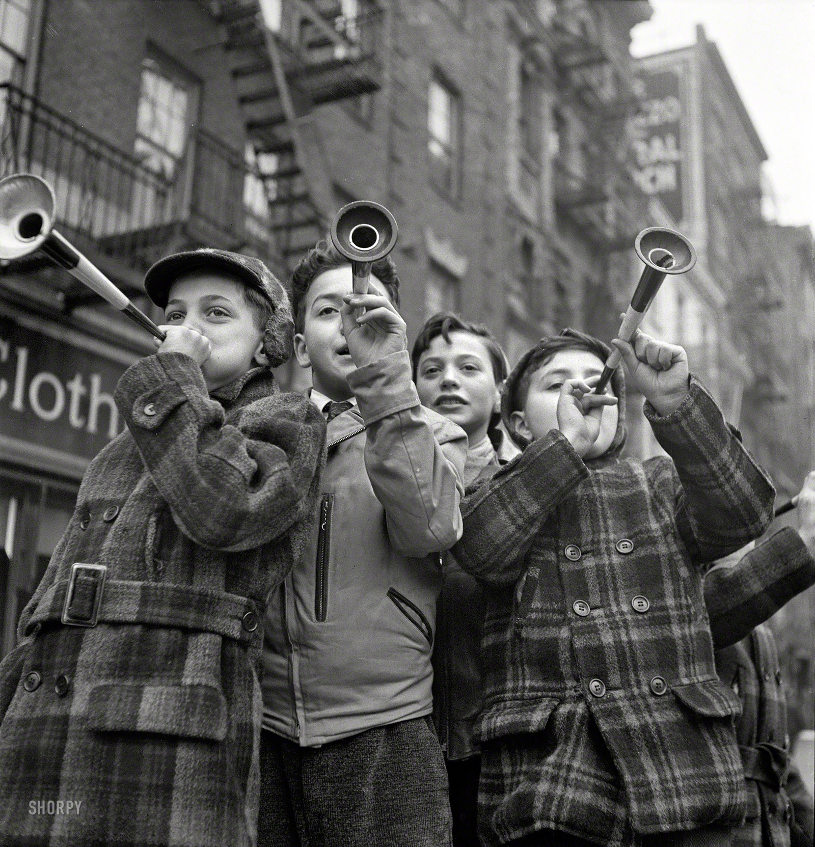 January 1, 1943. "New York. Blowing horns on Bleecker Street on New Year's Day." Photo by Marjory Collins, Office of War Information. View full size.