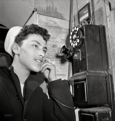 January 1943. "New York. Sixteen-year-old boy who is in the naval reserve on Mulberry Street." Along with a trove of telephone graffiti that looks as old as he is. Photo by Marjory Collins for the Office of War Information. View full size.